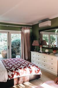 a bedroom with a bed and a large mirror at Treehouse Southern Highlands in Moss Vale