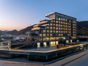 a large building with lights on in a city at SSAW Yintai Boutique Hotel Qiandao Lake in Chun'an