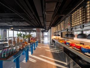 a restaurant with long tables with food on them at SSAW Yintai Boutique Hotel Qiandao Lake in Chun'an
