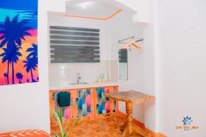 a kitchen with a sink and a table in a room at Cris Del Mar Resort in Bolinao