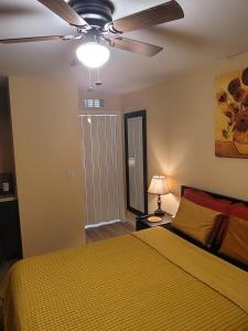 a bedroom with a bed and a ceiling fan at Twin Pines Studios in Jacksonville