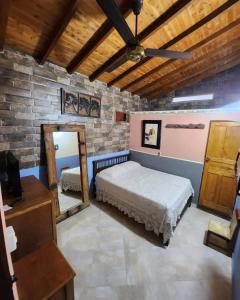 a bedroom with a bed and a mirror at Hotel Atenas in Jericó +35 photos