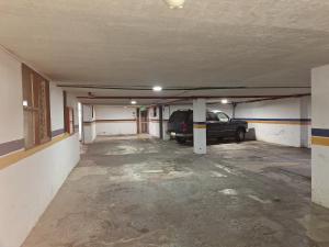 an empty parking garage with a car parked in it at Hotel Calima in Quito