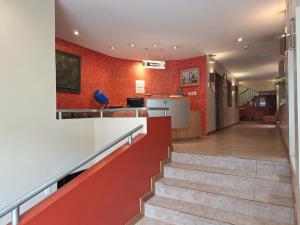 a staircase in a house with red walls at Hotel Calima in Quito