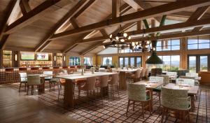 a restaurant with wooden ceilings and tables and chairs at Canopy By Hilton Deer Valley in Park City