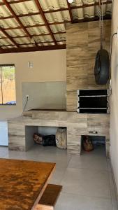 a kitchen with a counter and a table in a room at Refúgio do ipê in Pedra Menina +11 photos