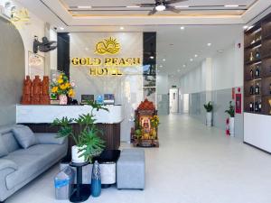 a lobby of a store with a blue couch at Hotel Gold Beach in Phương Phi