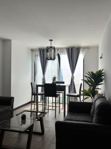a living room with a couch and a table at Escápate- Roomgt in Boca Monte