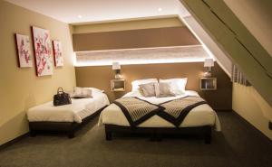 Katil atau katil-katil dalam bilik di Hotel Au Nid De Cigognes