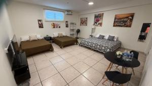 a living room with a couch and a bed at Beit Shalom habitaciones con clima in Orizaba