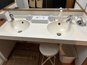 a bathroom counter with two sinks and a mirror at 竹葉庵 in Nagaokakyo +7 photos
