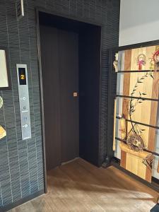 a door into a room with a painting on the wall at 竹葉庵 in Nagaokakyo