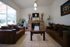 a living room with two couches and a fireplace at Casa Los Agapandos in Valle de Bravo
