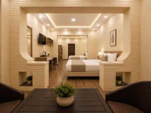 a hotel room with a bed and a desk at Pyramids Front Gate Hotel in Cairo
