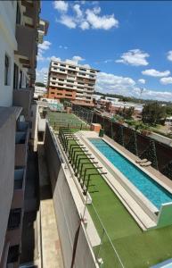 a pool on the roof of a building at Apartamento 2 dormitorios 1 baño parqueo in Boca Monte