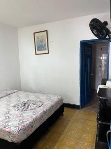 a bedroom with a bed and a blue door at Guiapa en melgar in Melgar