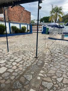 a patio with an umbrella and tables and chairs at Guiapa en melgar in Melgar