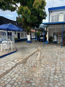 a parking lot in front of a building with a tree at Guiapa en melgar in Melgar