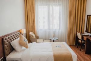 a hotel room with a bed and a window at ocean dragon in Ha Long +18 photos