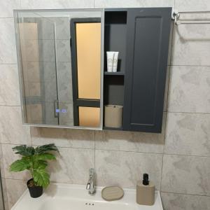 a bathroom sink with a medicine cabinet and a mirror at Le Cocon coloré Work and Chill KÉgué in Avéimé +38 photos