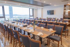 a large conference room with long tables and chairs at ocean dragon in Ha Long