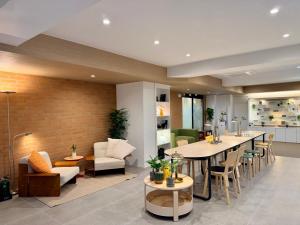 a restaurant with a long table and chairs at Link B Hotel in Busan