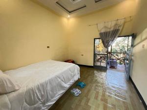 a bedroom with a bed and a large window at Addis View Homestay in Lalibela