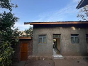 a small house with a hallway leading to a door at Addis View Homestay in Lalibela