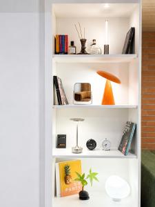a book shelf with books and a plant on it at Link B Hotel in Busan