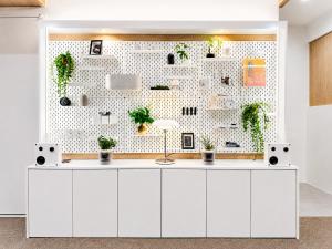 a white kitchen with plants on a wall at Link B Hotel in Busan +9 photos