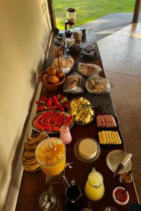 a table with many different types of food on it at Hotel Fazenda Haras RD in Olímpia