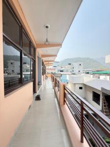 an empty corridor of a building with windows at Moon and Root in Narendranagar