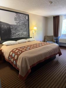 a hotel room with a bed and a large window at LaVale Inn Cumberland Area in La Vale