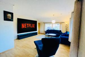 a living room with a netflix sign on the wall at Alam,s Villa in Kabelvåg