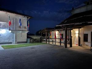 a building with flags on it at night at Family in Envie