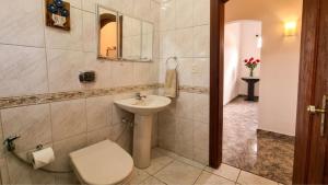 a bathroom with a sink and a toilet and a mirror at Refúgio Tiradentes in Tiradentes +155 photos