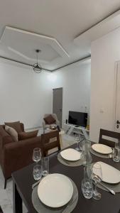 a living room with a table with plates and glasses at Les résidences Merryke 1 in Abidjan