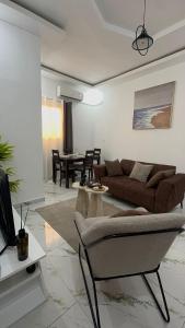 a living room with a couch and a table at Les résidences Merryke 1 in Abidjan