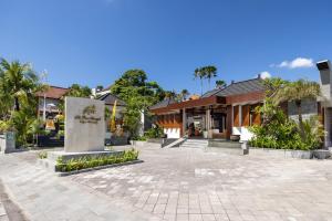 a courtyard of a building with trees and buildings at The Prime Seminyak by Kanaya Hospitality in Seminyak