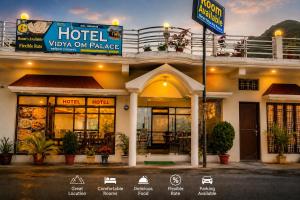 a hotel with a sign in front of it at Hotel vidya om palace in Ukhimath