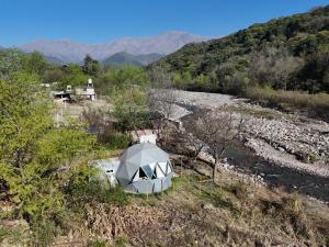 a tent in the middle of a field with mountains at Domo Yala in Yala