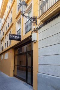 un edificio con un cartel en el costado en Apartamentos Massò en Albacete