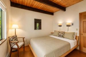a bedroom with a bed and a chair at Icicle Chalet in Leavenworth