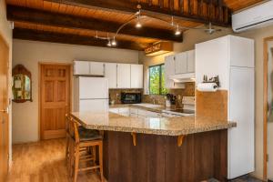 a kitchen with white appliances and a counter top at Icicle Chalet in Leavenworth
