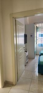 an open door to a room with a couch and a television at Mali's Apartment in Tirana