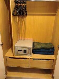 a microwave sitting on a shelf in a closet at Flat Aeroporto Congonhas in São Paulo +7 photos