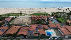 an aerial view of a house and the beach at Pousada Virgínia in São Gonçalo do Amarante