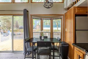 a dining room with a black table and chairs at The Nook Tiny Home Fire Pit Close to Lake in Maple Lake +26 photos