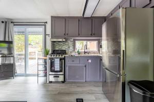 a kitchen with purple cabinets and a refrigerator at The Cranny Tiny Home Fire Pit Close to Lake in Maple Lake +27 photos