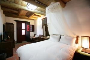 Postel nebo postele na pokoji v ubytování Qiong Lin 79 Hao Homestay
